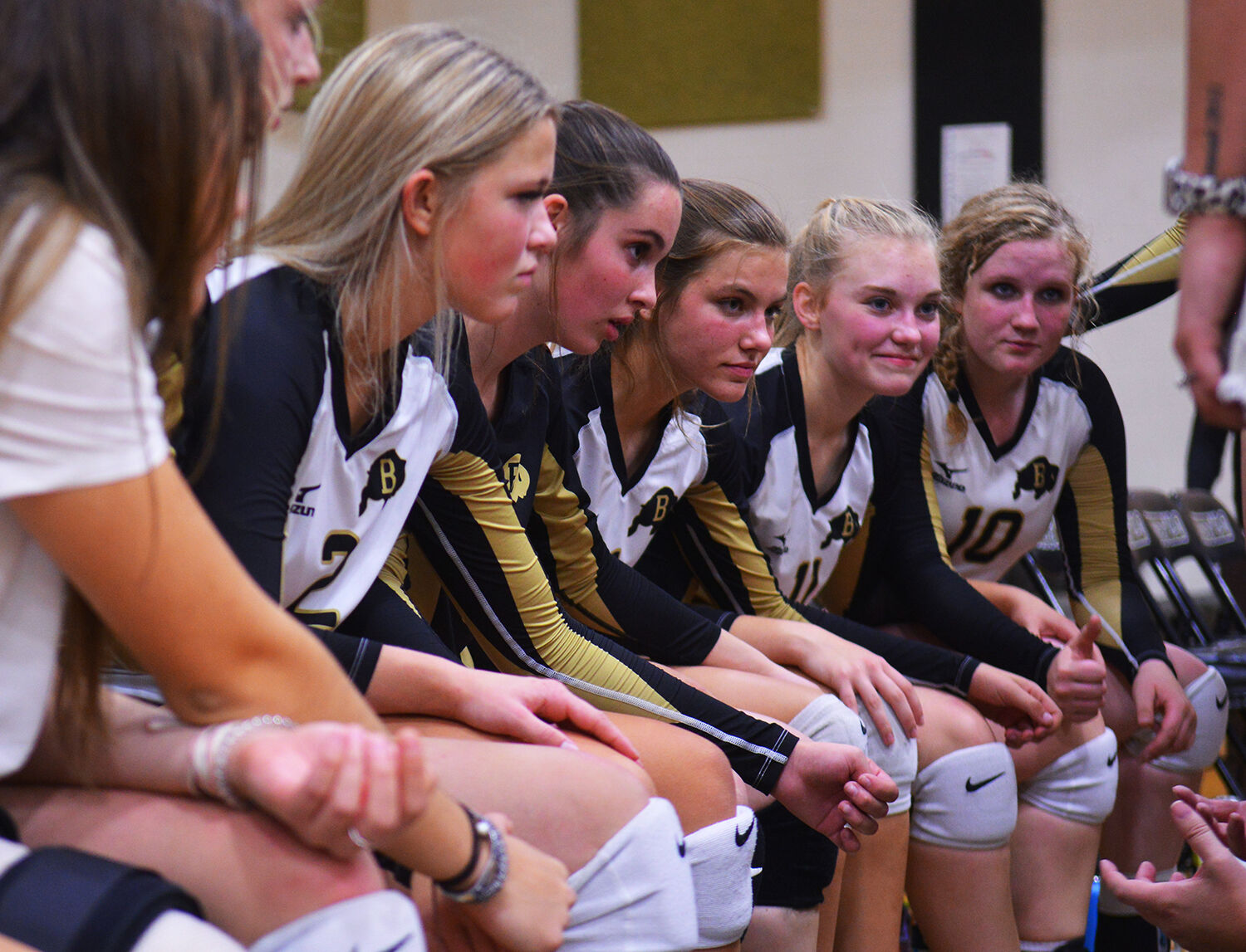 Buffalo's varsity starters sit on the bench listening to coach Landrey